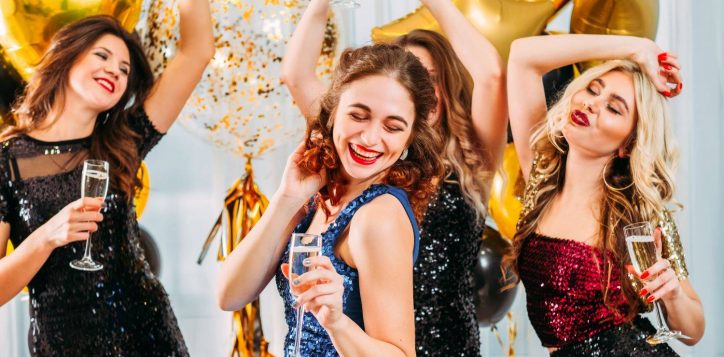 ladies-celebrating-their-college-graduation-home-girls-dancing-with-champagne-room-decorated-with-balloons-2
